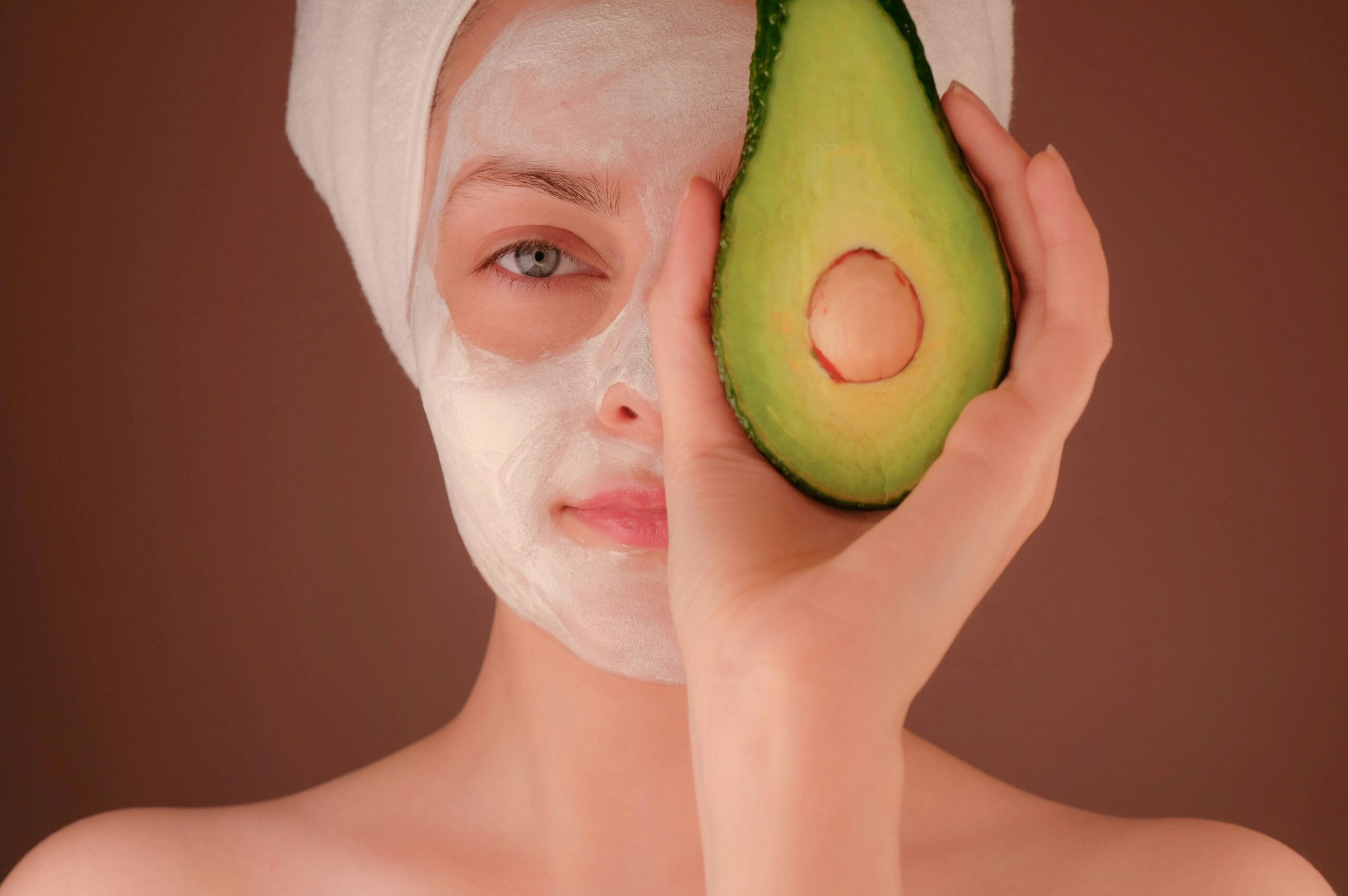 woman with white face woman with white face mask holding green fruit